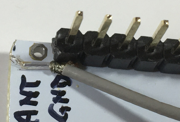 Insert the coax cable braid and center conductor in the PCB holes